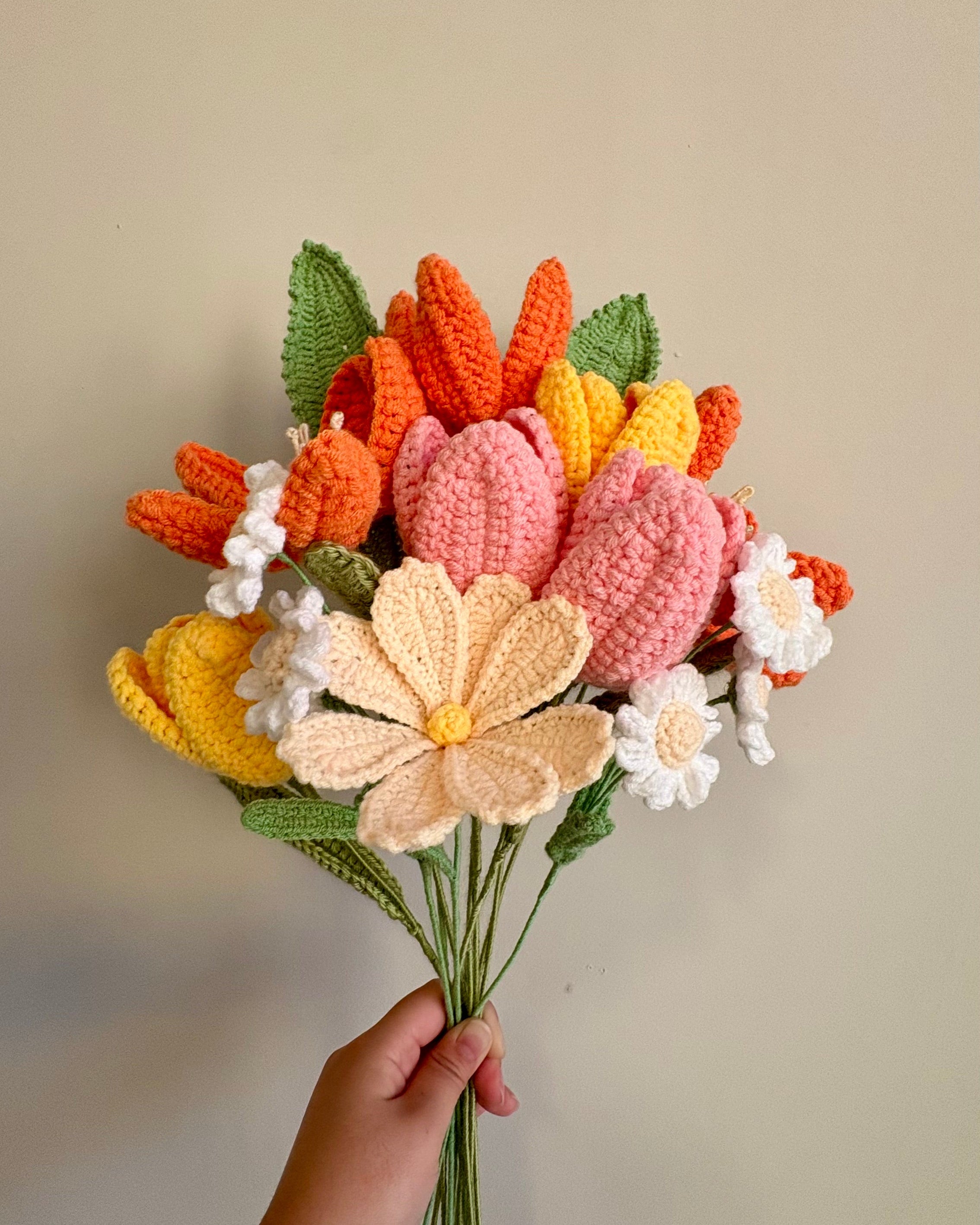 bouquet of orange, yellow, and pink crochet flowers